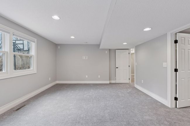 Lower level 4th bedroom has fresh paint and new carpet. Bedroom looks out to backyard and faces south. | Image 31