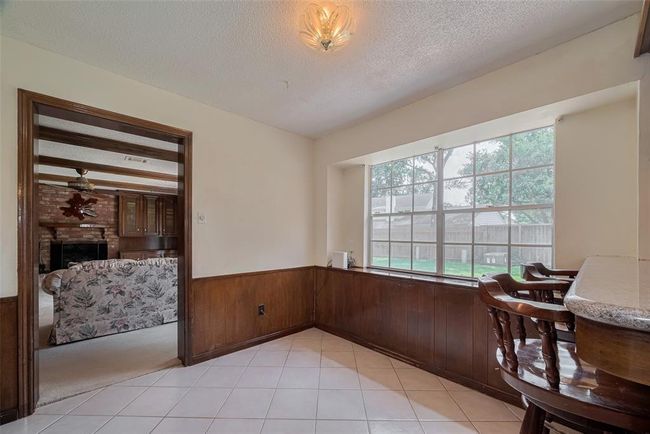 Cozy breakfast nook with picturesque backyard views. | Image 12