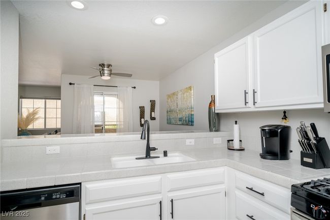 Kitchen featuring recessed lighting, a sink, a ceiling fan, white cabinetry, and dishwasher | Image 12