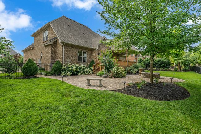 Catch this side view of the paved patio and fire pit—the perfect place to entertain. | Image 42