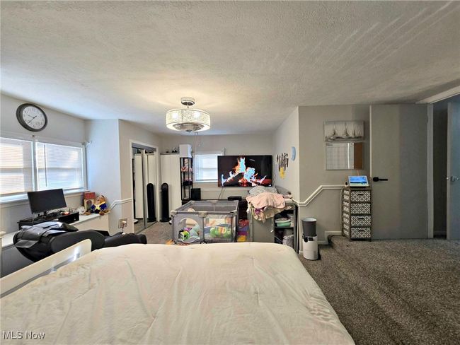 Bedroom featuring carpet and a textured ceiling | Image 30