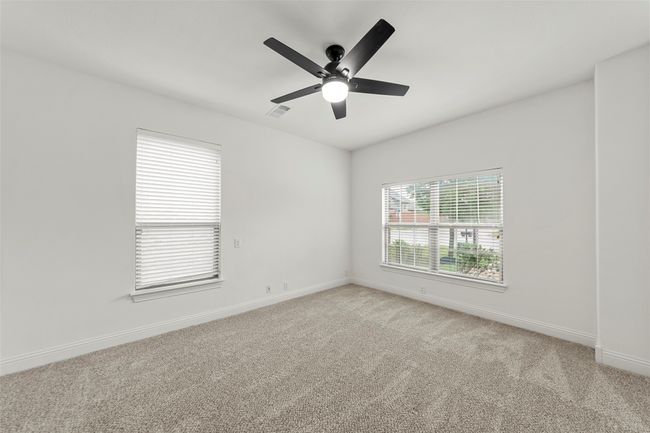 Spare room with ceiling fan, light colored carpet, baseboards, and visible vents | Image 26