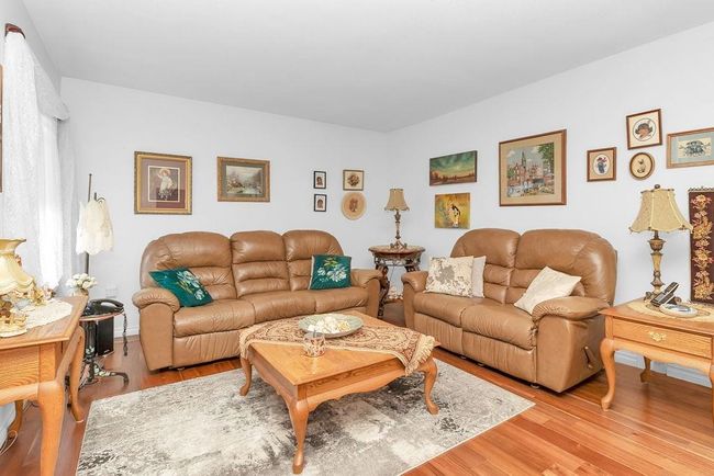 Living area with wood finished floors | Image 13