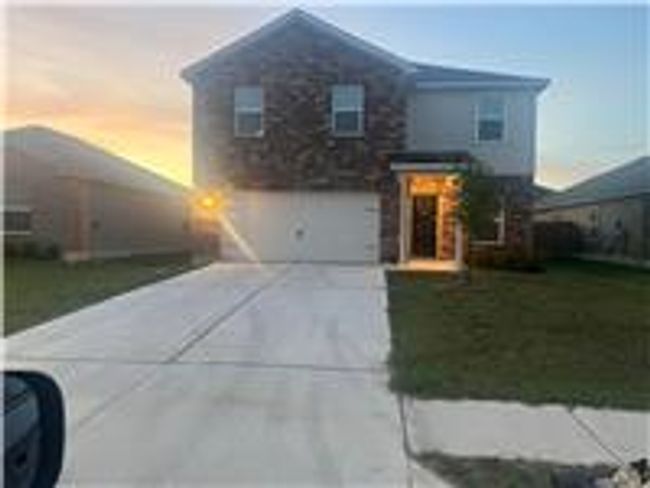 View of front facade with driveway, an attached garage, and a yard | Image 20
