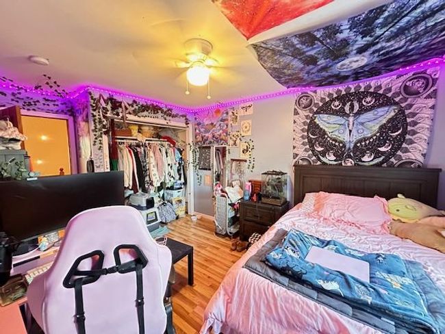 Bedroom with wood finished floors, a closet, and a ceiling fan | Image 30