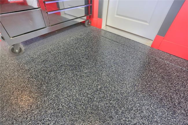 This garage is a car enthusiast’s dream—featuring custom wall accents, sleek epoxy flooring, overhead lighting, and enough space for multiple vehicles or recreational toys, all with a polished showroom feel. There's a heater and LED lighting as well as a 220 line for a car charger. | Image 47