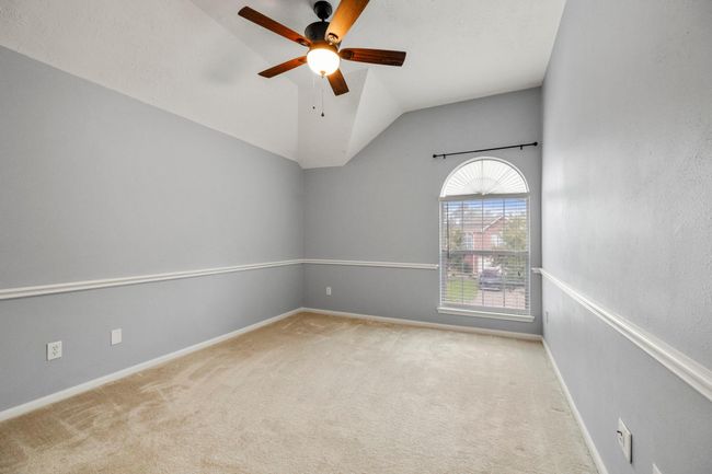 Another upstairs bedroom with vaulted ceilings and a picture window—each secondary room includes a walk-in closet. | Image 30
