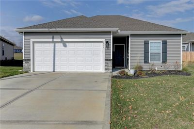 Single story home with a garage and a front lawn | Image 1