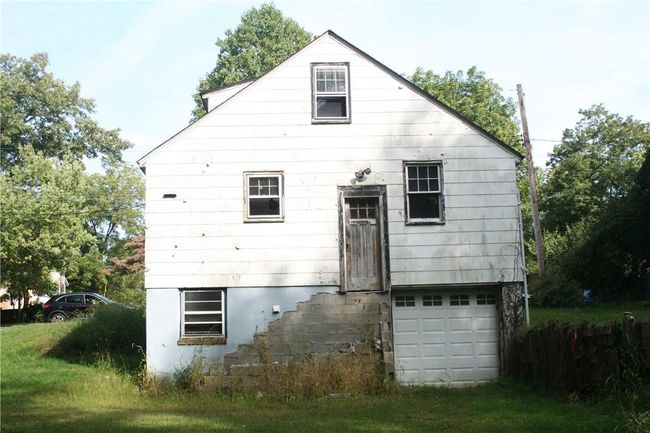 Back of house with a lawn and a garage | Image 9