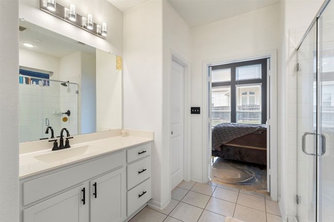 Ensuite bathroom featuring a stall shower, vanity, and tile patterned flooring | Image 16