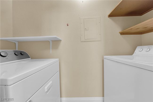 Washroom with washing machine and dryer, electric panel, and laundry area | Image 13