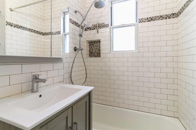 Renovated full bath featuring vanity and bathing tub / shower combination | Image 7