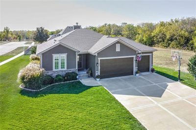 View of front of property with a front yard and a garage | Image 1