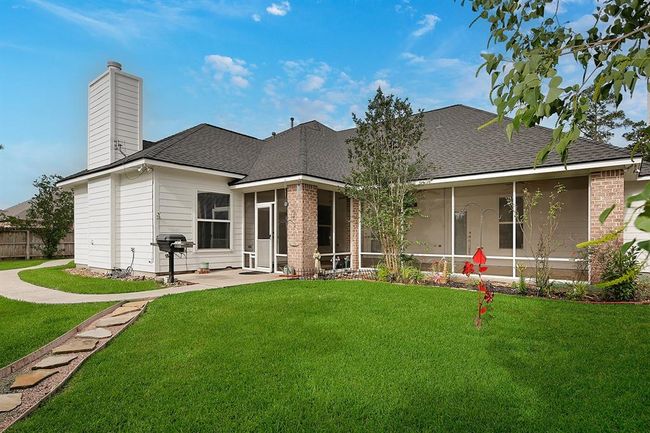 View of back of the house with screened in porch and grill area | Image 26