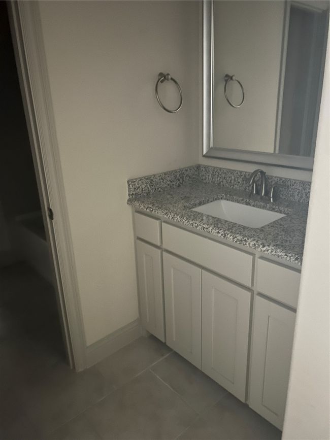 Bathroom with vanity, tile patterned floors, and baseboards | Image 13