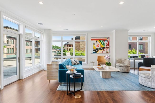 This corner unit boasts expansive windows that flood the space with an abundance of natural light | Image 9