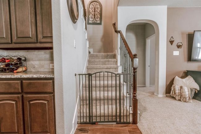Stairway featuring baseboards, arched walkways, and carpet flooring | Image 28