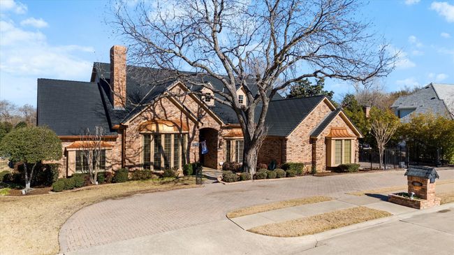 Convenient circular drive as well as a side driveway to the 3 car garage and gate. | Image 7
