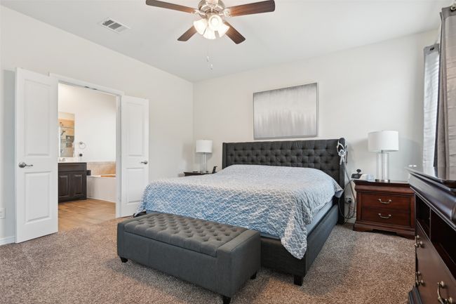 Bedroom featuring carpet floors, ensuite bath, and a ceiling fan | Image 28