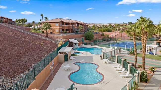 Community pool featuring fence, a patio area, and a residential view | Image 48