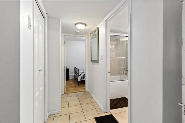 Hall featuring light tile patterned floors and baseboards | Image 28