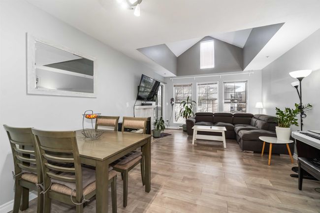 Dining room with high vaulted ceiling, light wood-type flooring, and baseboards | Image 6