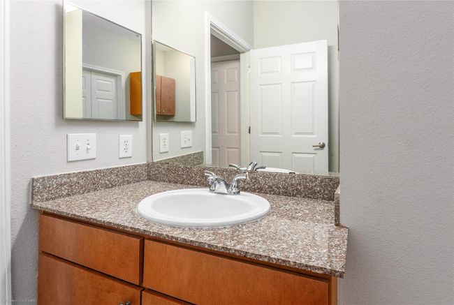 Bathroom featuring vanity and a textured wall | Image 17
