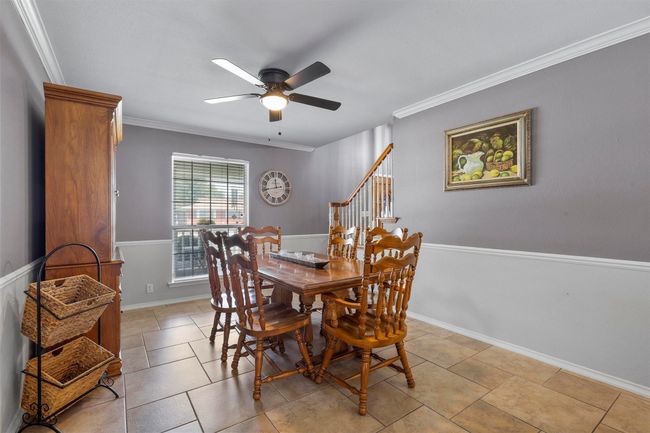 Dining space featuring ornamental molding, ceiling fan, and light tile floors | Image 17