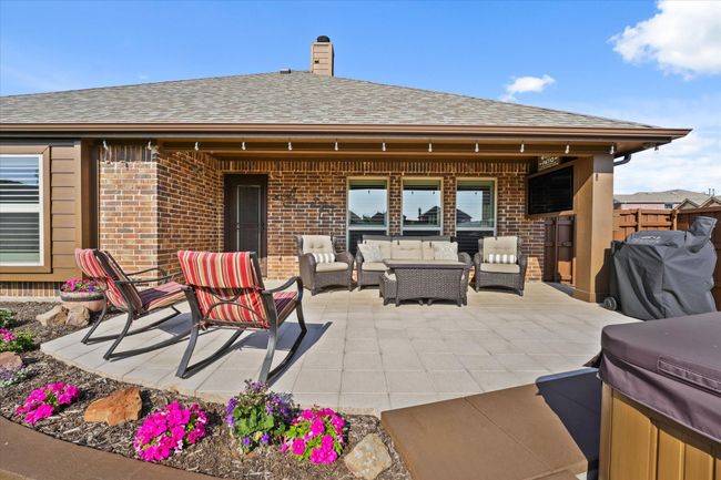 View of patio with grilling area and an outdoor hangout area | Image 35