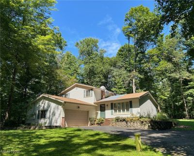 Nestled in the woods, this split level home has much to offer. | Image 1