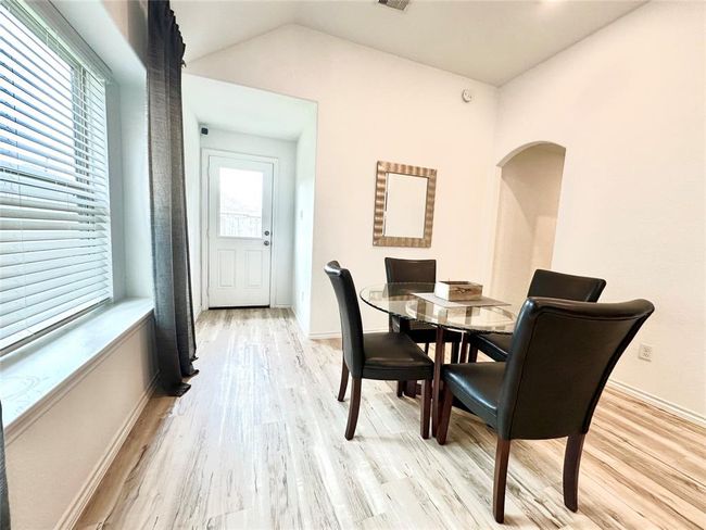 Another view of kitchen/dining room combo with arched opening that leads to primary retreat which is separate from additional bedrooms. | Image 12