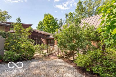 From this angle, the variety of angles, materials, and textures of the home seem to grow out of the natural environment. | Image 2