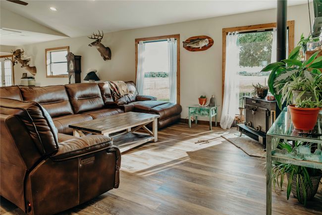 Living area featuring healthy amount of natural light, recessed lighting, wood finished floors, lofted ceiling, and a ceiling fan | Image 4