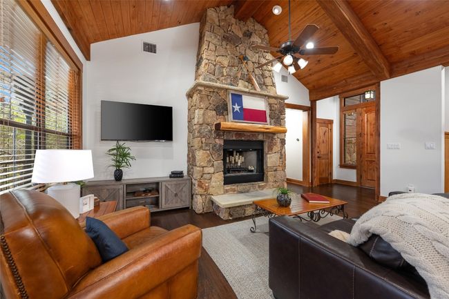 Wood-paneled ceilings add warmth and rustic appeal to the main living space. | Image 8