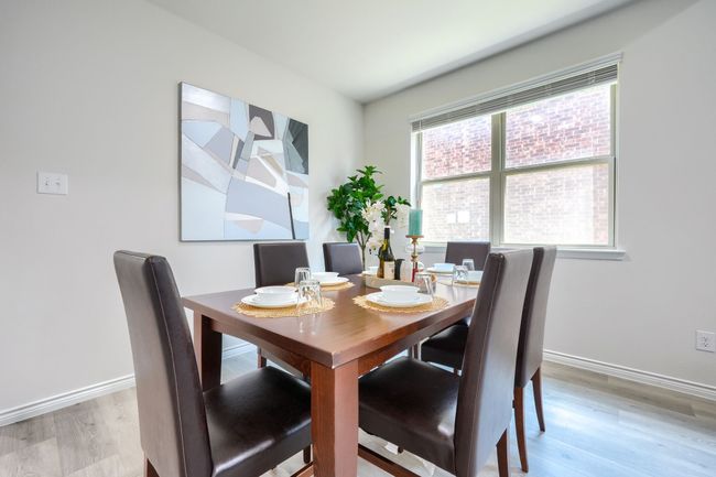 Dining space with light wood finished floors and baseboards | Image 4