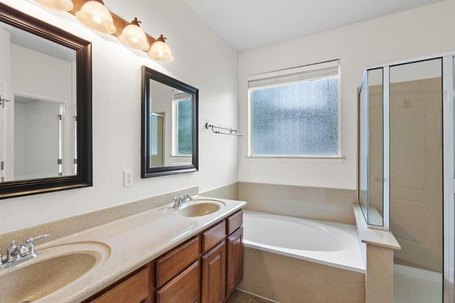 Full bathroom with a shower, a garden tub, double vanity and large walk in closet | Image 17