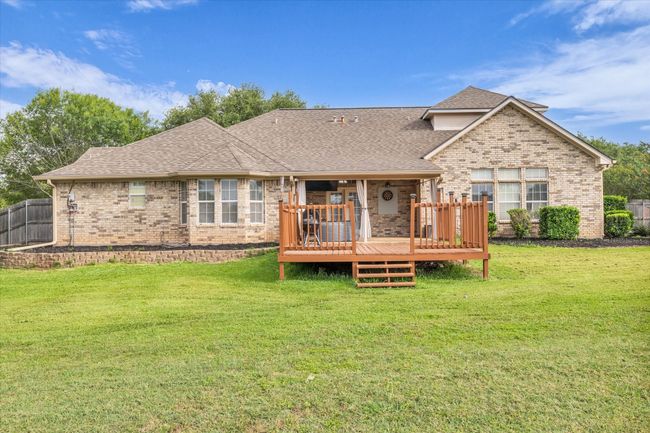Back of house featuring brick siding, roof with shingles, and a wooden deck | Image 31