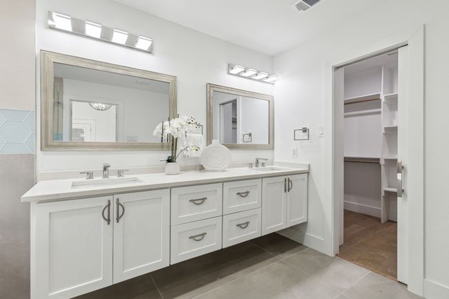 Bathroom with tile patterned flooring, double vanity, visible vents, and a sink | Image 23