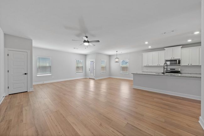 The heart of this remarkable home is the main living area, where the family room, dining room and the incredible kitchen come together to create a space that's truly the heart and soul of this property. | Image 7
