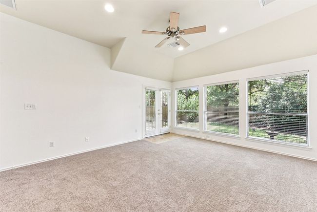 Another view of the primary bedroom with beautiful windows and private access to your covered back patio | Image 27