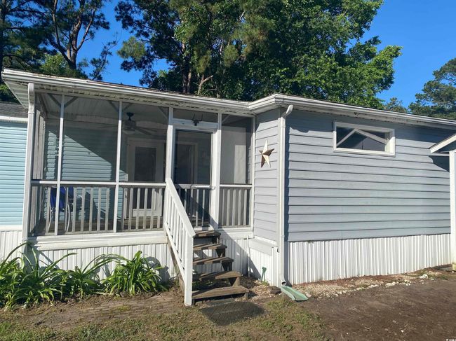 View of front of house with a ceiling fan and a sunroom | Image 8