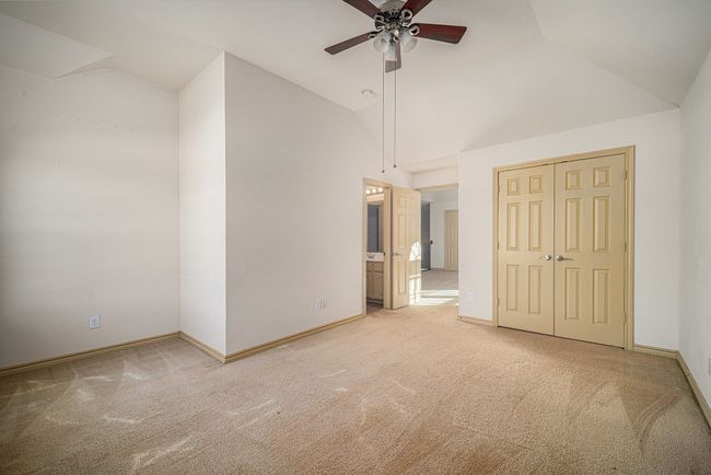 Unfurnished bedroom with carpet flooring, high vaulted ceiling, and baseboards | Image 27