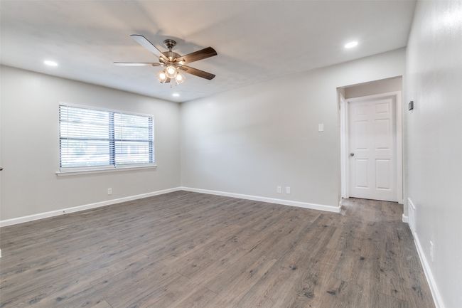 Spare room with ceiling fan, wood finished floors, and recessed lighting | Image 7