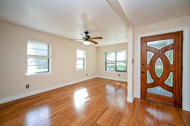 Beautiful bamboo floors and large windows, throughout most of the downstairs, create a natural light, bright feel of the home. | Image 5