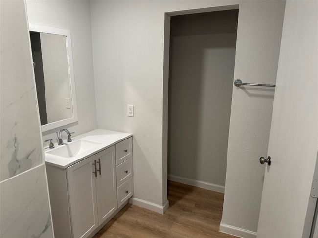 Bathroom with baseboards, wood finished floors, and vanity | Image 33