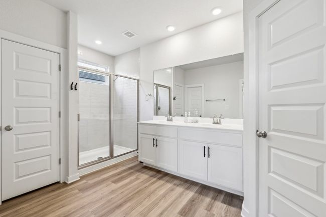Unwind in your luxurious spa-like bathroom with dual vanities and ample storage. | Image 8