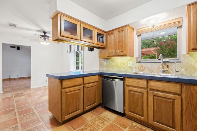 Kitchen with dishwasher, dark countertops, healthy amount of natural light, and a peninsula | Image 7