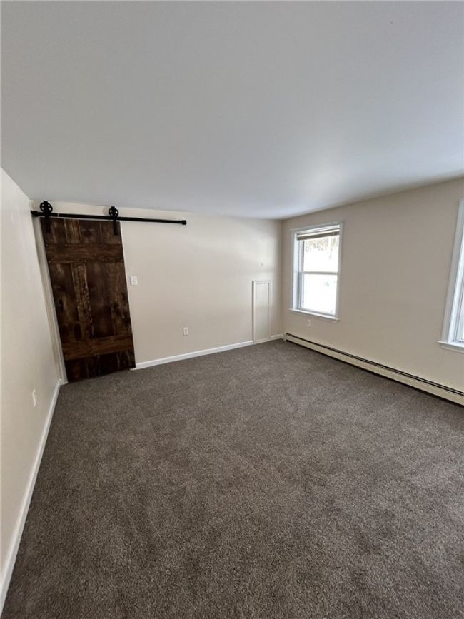 Bedroom 1 - Slider barn door to Bathroom 1 | Image 9