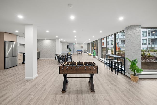 Game room featuring recessed lighting, light wood-style floors, and a wall of windows | Image 22