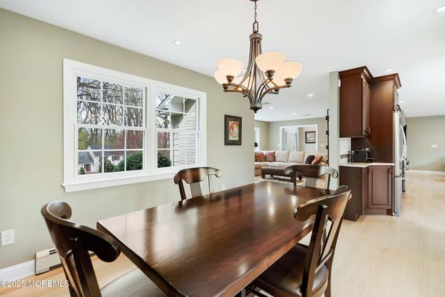 Formal Dining room sits between kitchen and living room for easy entertaining | Image 15